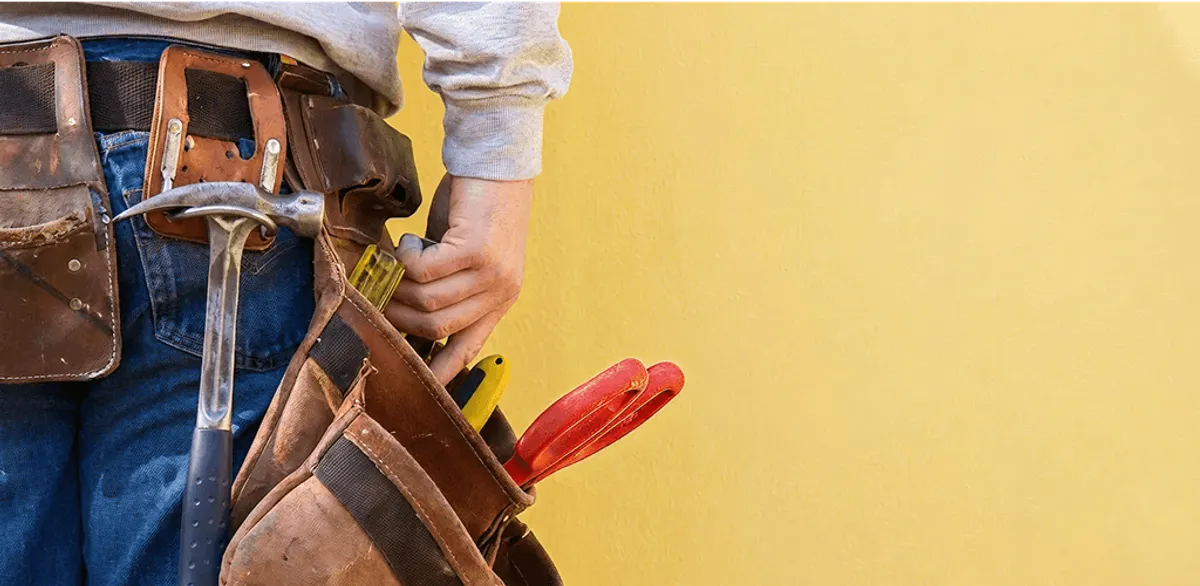 Handyman with tool belt ready for home repairs and maintenance in Charleston, SC