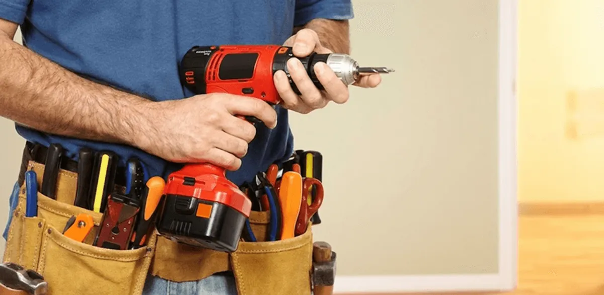 Handyman holding a power drill for home repairs and installations in Charleston, SC